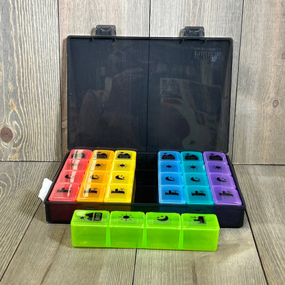 Extra large weekly pill organizer with colorful compartments, perfect for vitamins, fish oil, and supplements, open on wooden table.