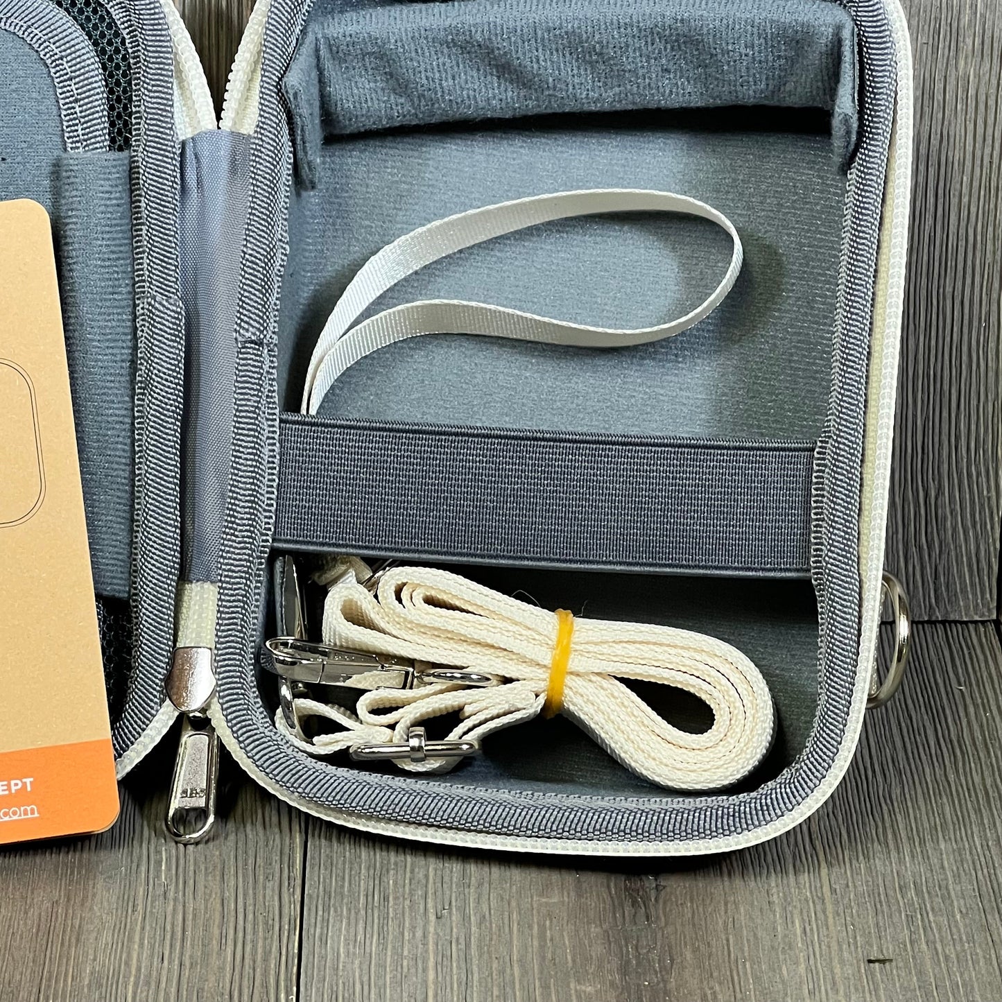 Beige K&F Concept camera bag interior with straps and compartments, offering waterproof protection for small cameras.