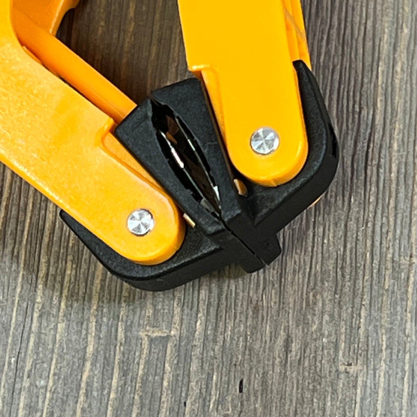 Close-up of orange temperature clamp for K Type Thermocouple Thermometer, featuring durable metal screws and robust design.