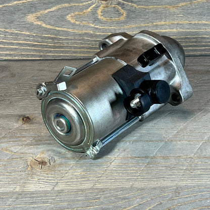 Compact starter motor for Honda Accord and Civic, ideal for 2013-2019 models, shown on a wooden surface.