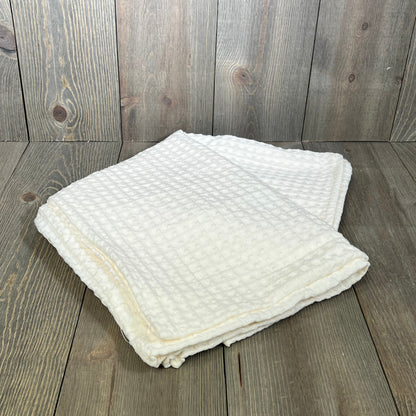 Ultra soft coconut white waffle weave pillow shams on wooden surface, standard size 20"x26", stylish and breathable.