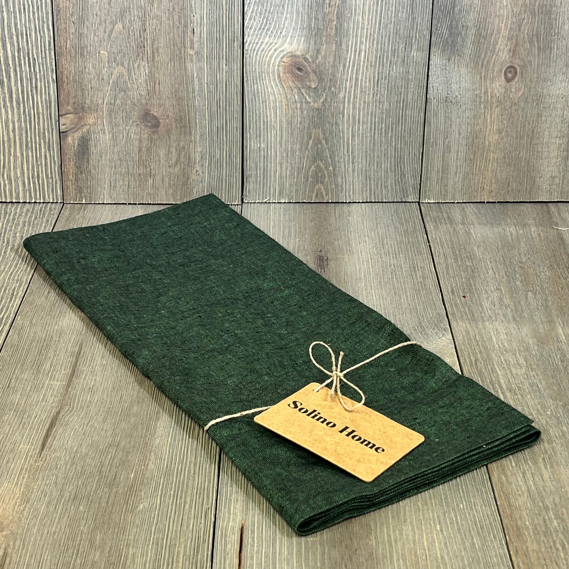 Forest green linen table runner, 14x36 inches, perfect for dressers and coffee tables, enhancing home decor elegance.