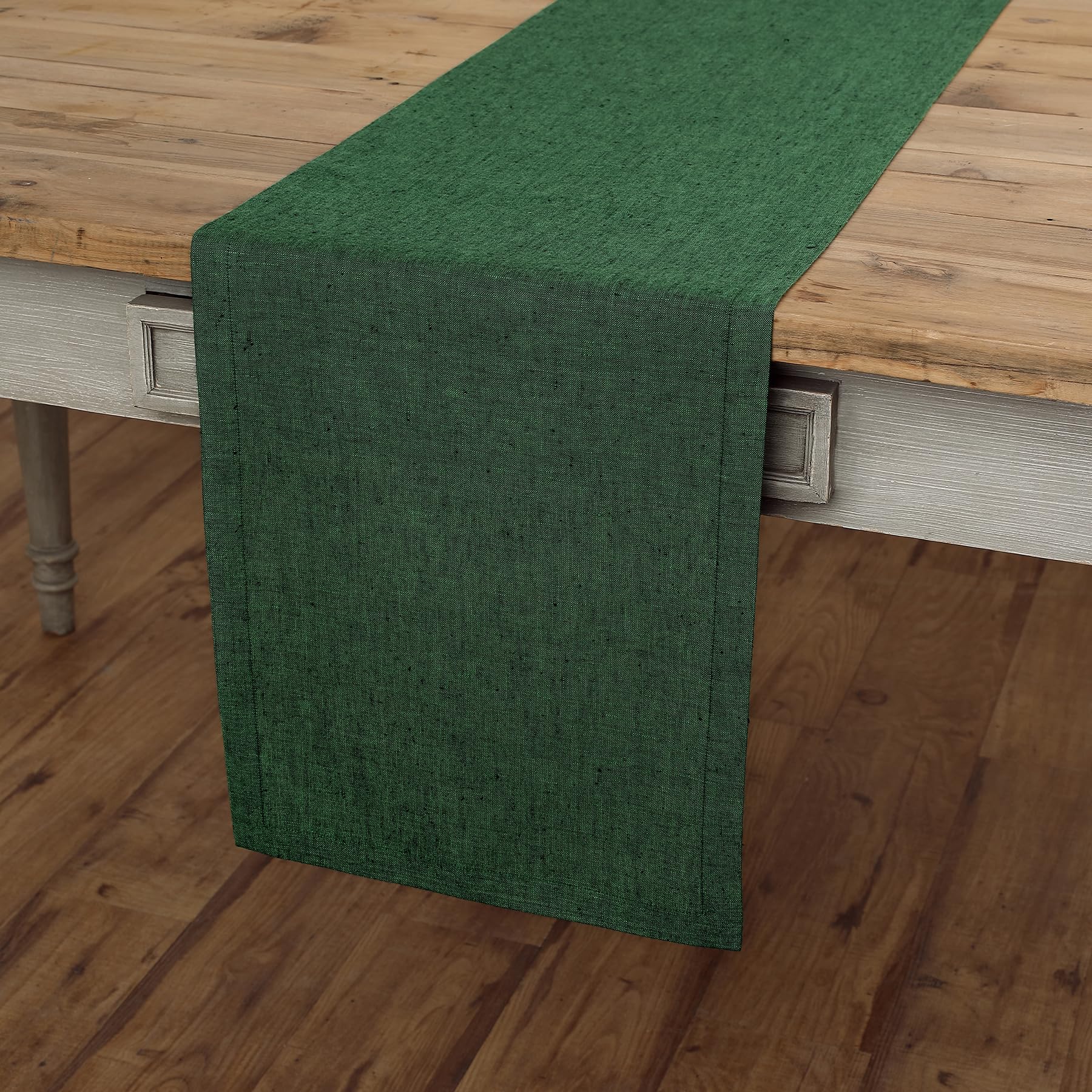Elegant forest green linen table runner on rustic wooden table, perfect for dressers and coffee tables, size 14 x 36 inches.