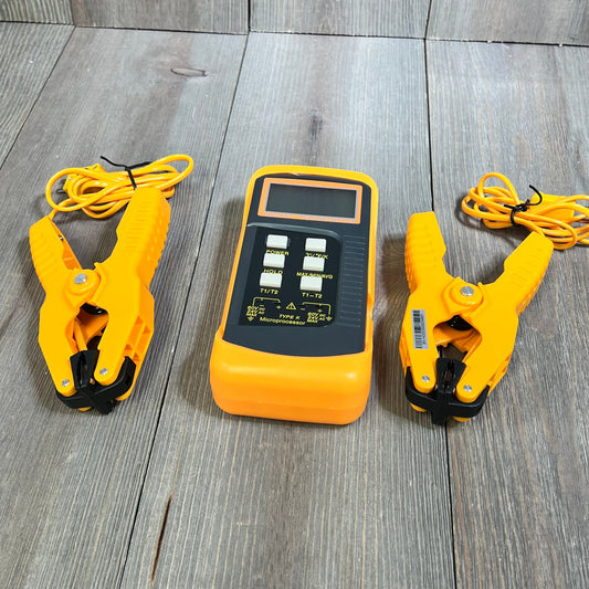 Dual-channel digital K Type thermocouple thermometer with two temperature clamps and wired probes on wooden surface.