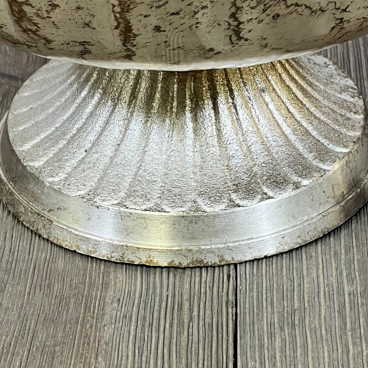 Distressed champagne metal compote bowl base on wood surface, ideal for elegant indoor and outdoor event decor.