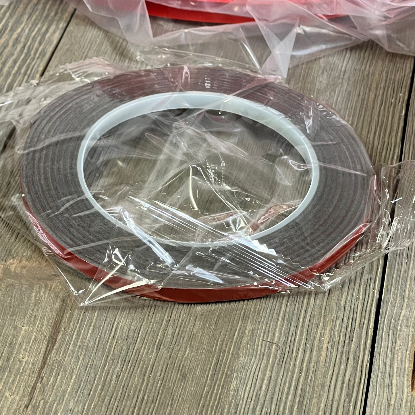 Red adhesive tape for Jeep Wrangler JL grille and headlight cover installation, ensuring secure attachment and durability.