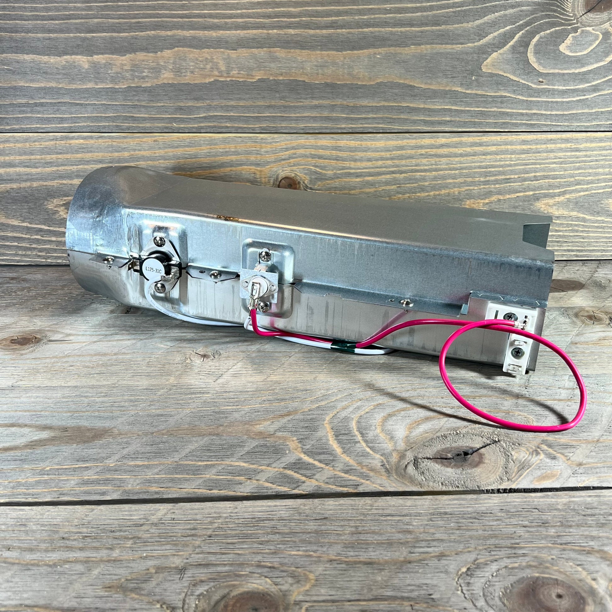 Dryer heating element 1048541548-5301EL1001H for LG and Kenmore, showcasing metal casing and wiring on wooden background.