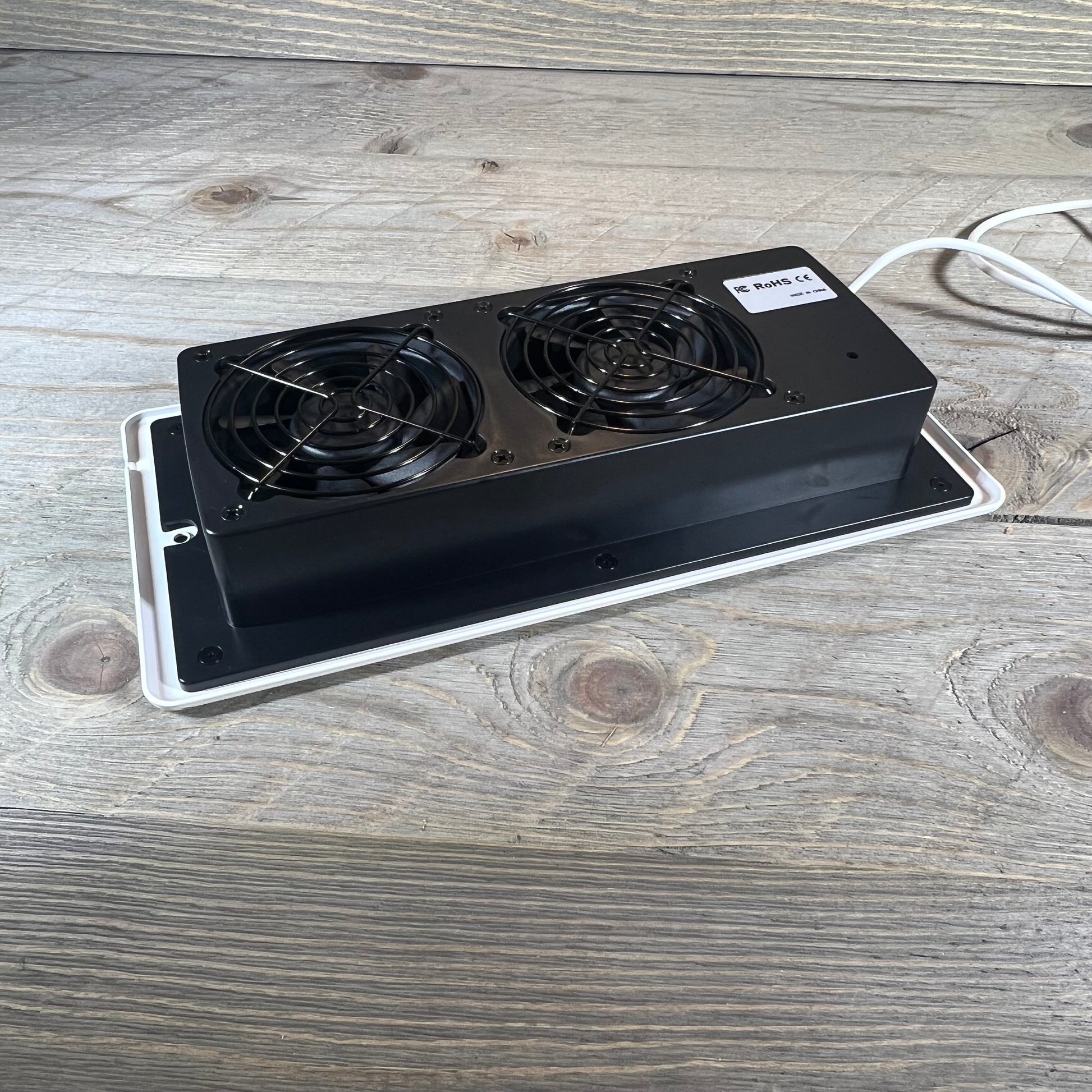 Dual-fan smart register booster for 4" x 10" vents, enhancing airflow efficiency with remote control.