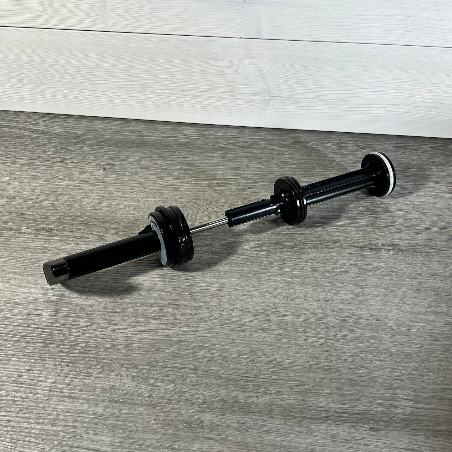 Durable GUOJINJISM SPX0410BA handle and piston assembly for Hayward slide valve on a wooden surface.