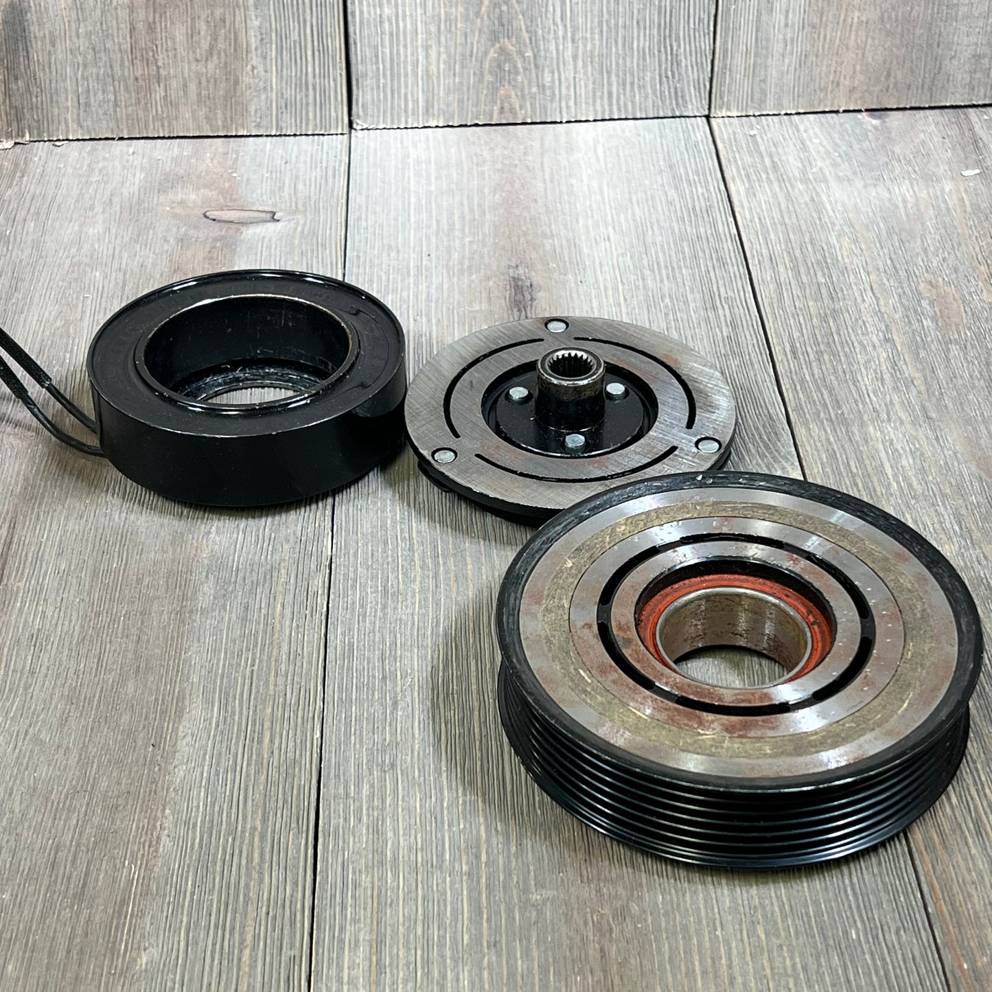 ECCPP AC clutch components for Hyundai Elantra and Kia Soul, showcasing durable design on wood surface.
