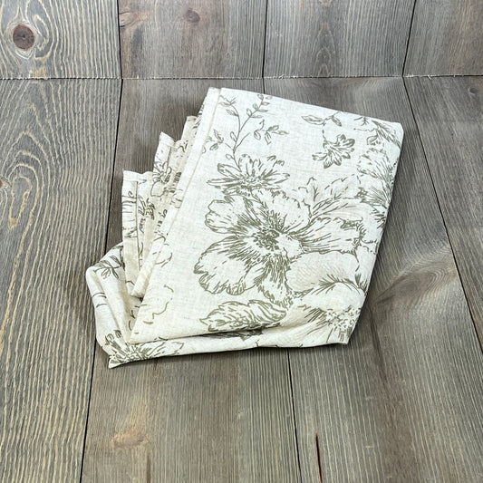 Folded jinchan linen tablecloth with floral green print on beige, ideal for farmhouse-style rectangle dining tables.