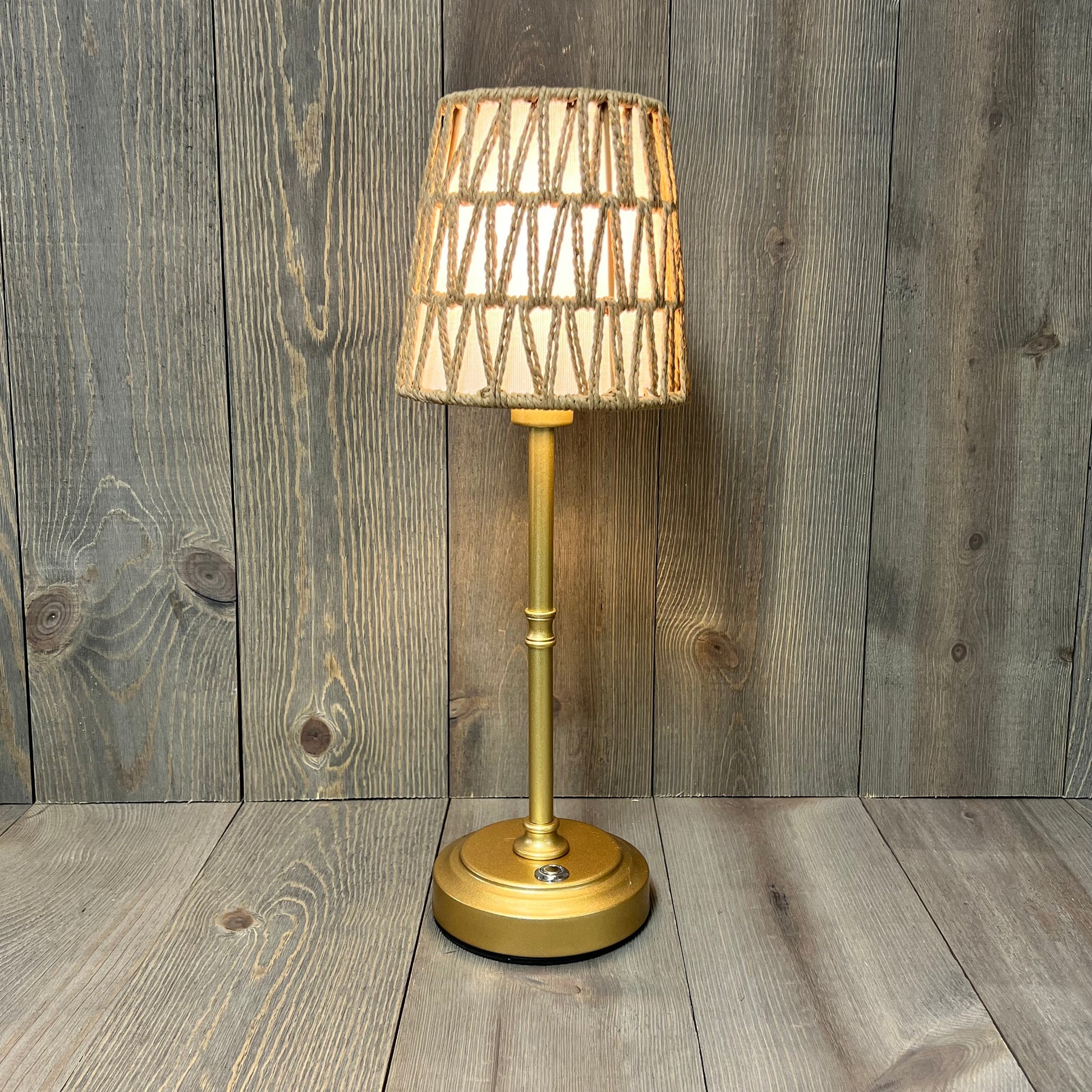 Gold rechargeable rattan cordless table lamp with a woven shade, ideal for bedside or nursery, featuring touch control dimming.