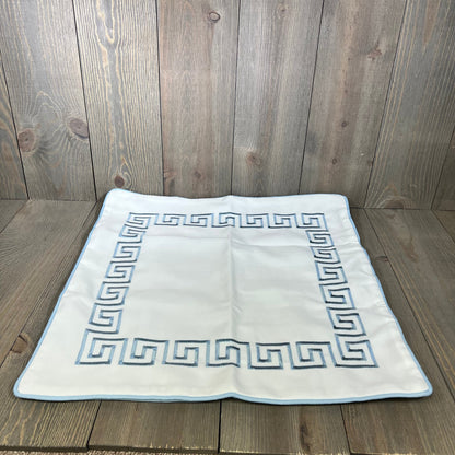 Baby blue embroidered Greek key pillow cover on wooden surface, showcasing premium quality and water-repellent fabric.