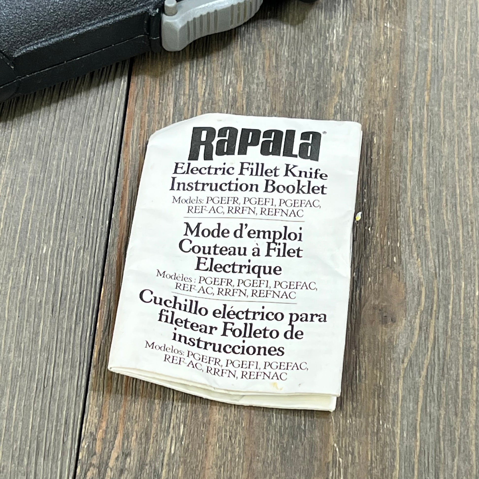 Rapala electric fillet knife instruction booklet on wooden surface