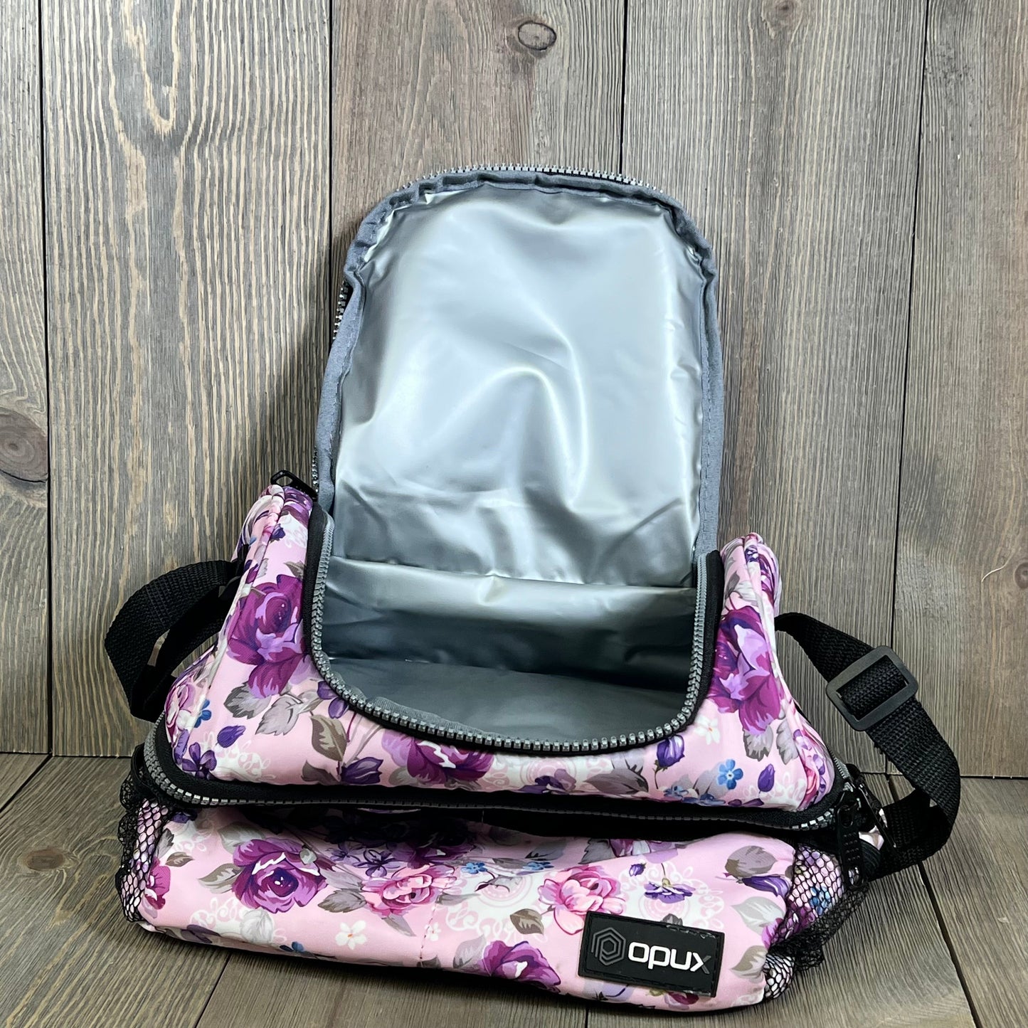 Floral purple Opux lunch box with large dual compartments, open to show insulated interior, ideal for women.