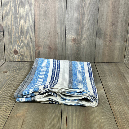 Folded outdoor lumbar pillow covers in blue stripes on wooden surface, perfect for patio, garden, or balcony decor.