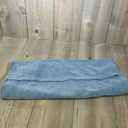 Dusty blue chenille pillow cover folded on rustic wood background, showcasing elegant texture and farmhouse style.