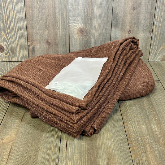 Chocolate brown linen curtains folded with a burlap texture, perfect for bedroom or living room decor.