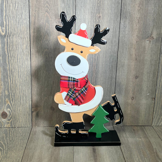 Festive reindeer decor with Santa hat and plaid scarf, perfect for farmhouse Christmas tabletop or mantel display.