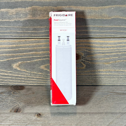 Frigidaire WF3CB refrigerator water filter cartridge in original packaging on wooden surface.