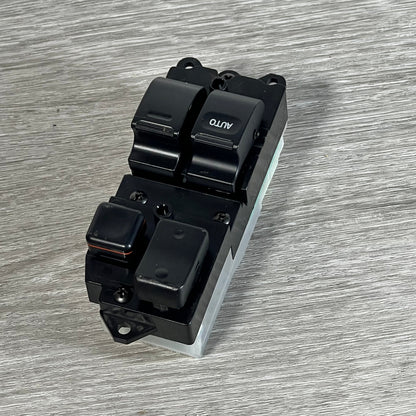Front view of Dorman 901-711 driver side window switch for Toyota, showcasing button layout on wood surface.