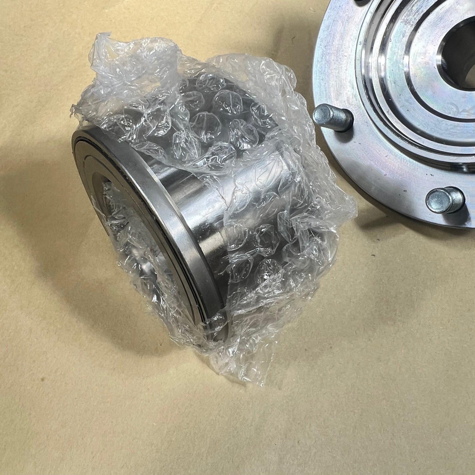 Front wheel hub bearing kit for Toyota Tundra and Tacoma, wrapped in bubble wrap, showcasing metal finish.