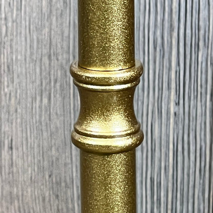 Close-up of the elegant gold stand of a rechargeable rattan cordless table lamp, showcasing its textured finish.
