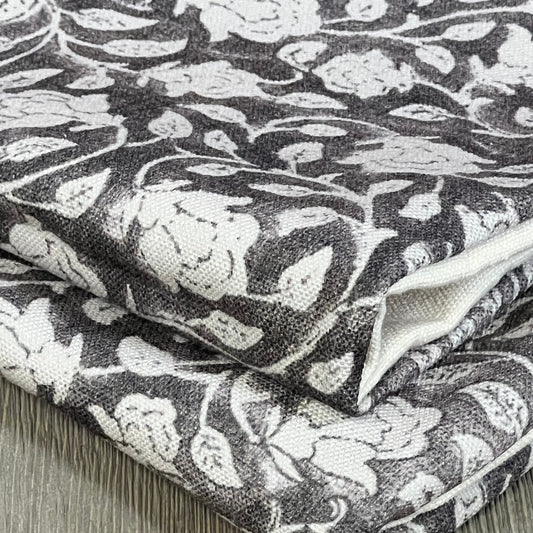 Floral taupe pillow cover with intricate white flower pattern, perfect for a stylish living room accent.