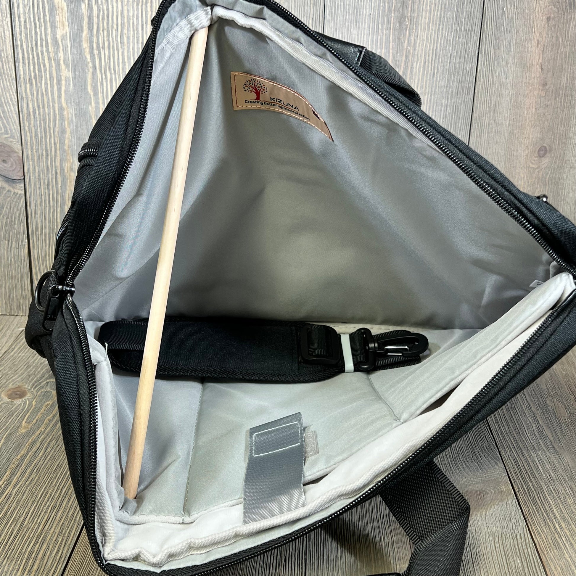 Spacious interior of KIZUNA 17-inch laptop bag, featuring padded compartments for secure device storage.