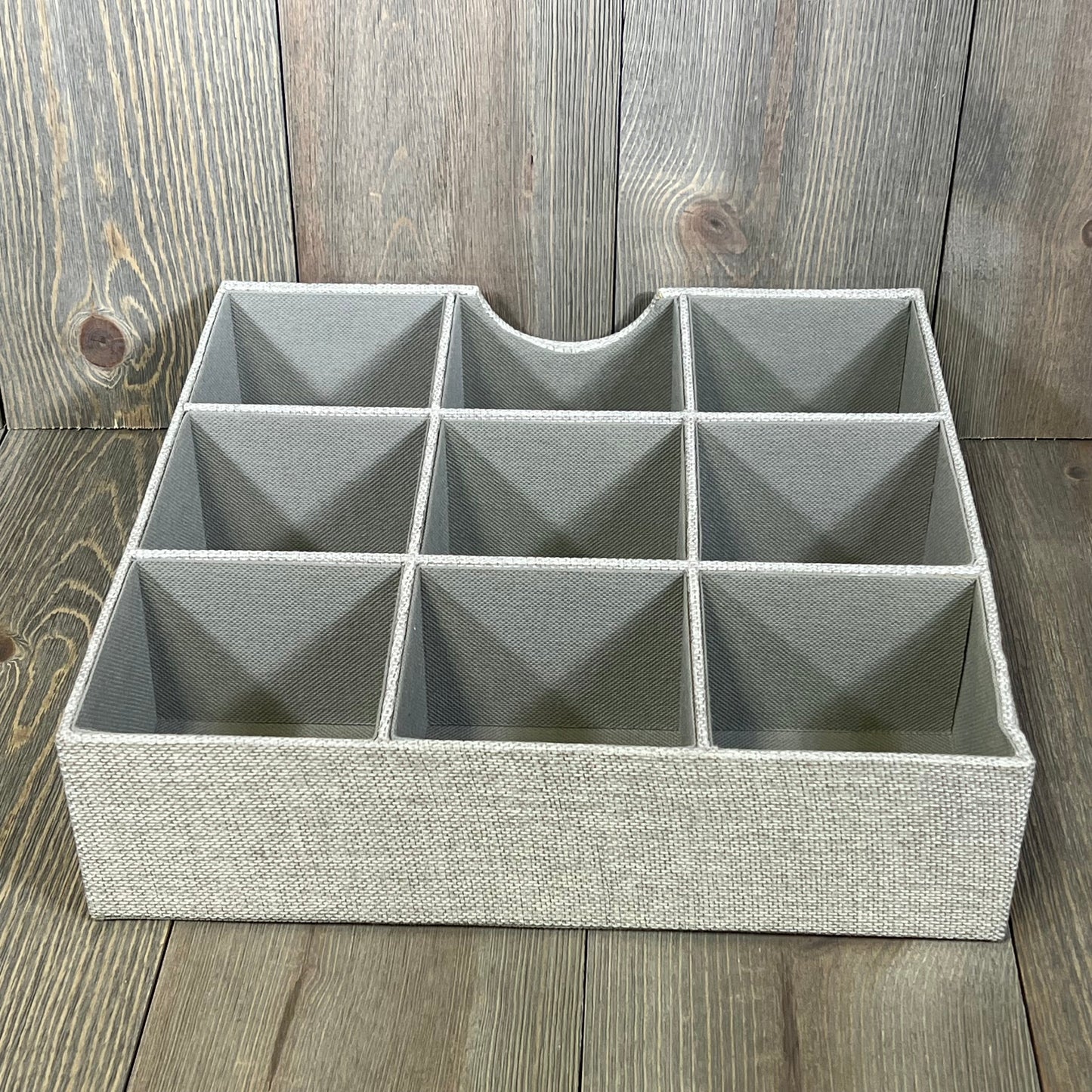 Gray fabric drawer organizer tray with nine compartments, ideal for organizing household essentials and maximizing drawer space.