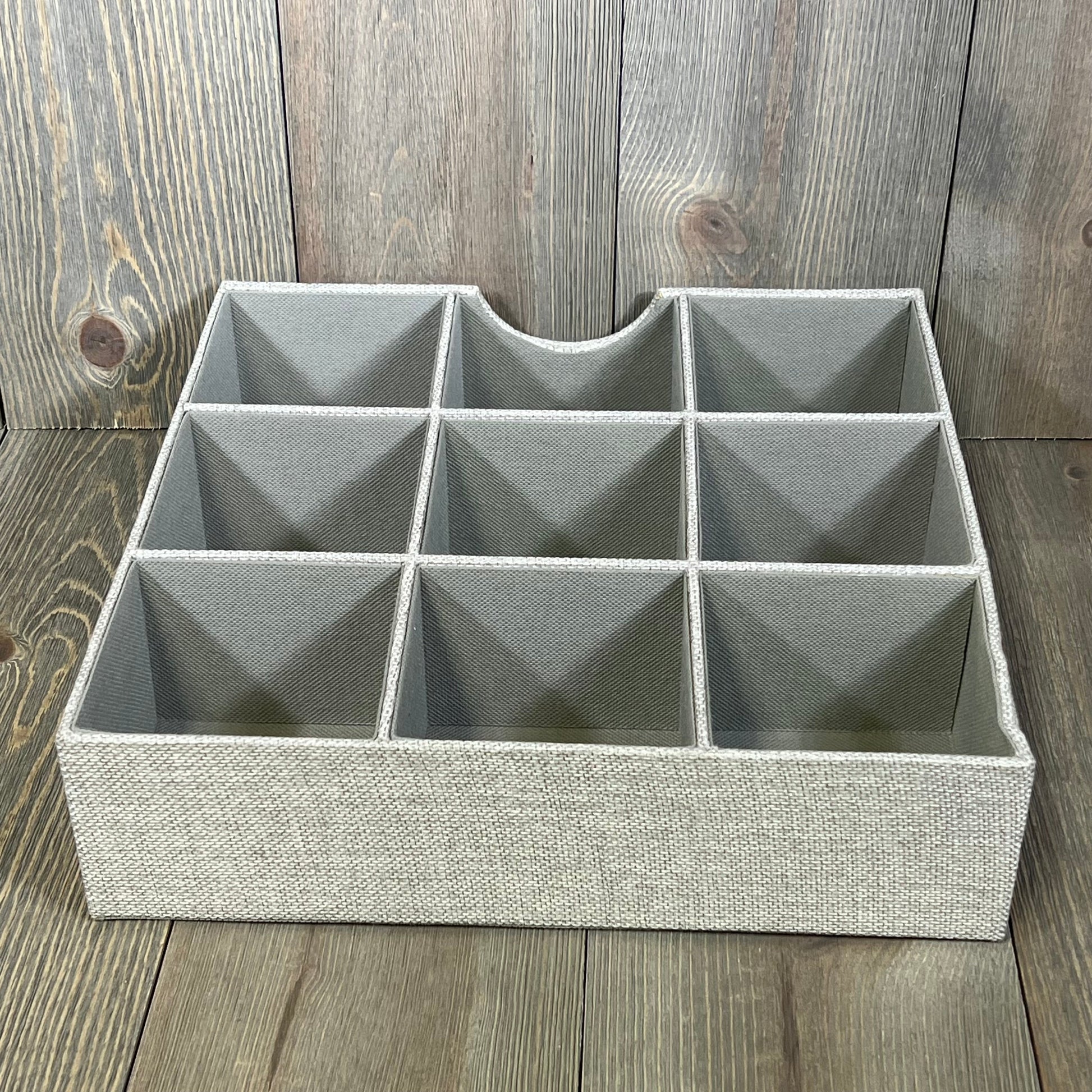Gray fabric drawer organizer tray with nine compartments, ideal for organizing household essentials and maximizing drawer space.