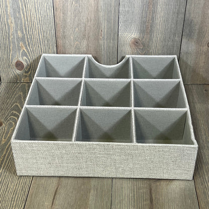 Gray fabric drawer organizer tray with nine compartments, ideal for organizing household essentials and maximizing drawer space.