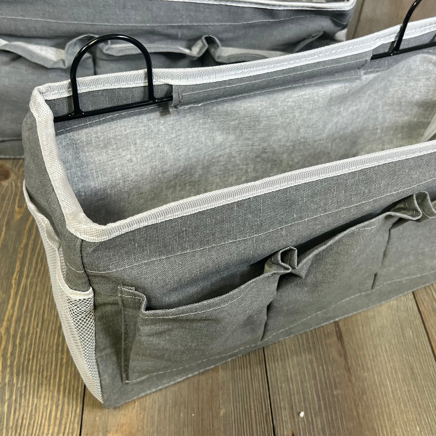 Gray linen wall hanging organizer with three spacious pockets, ideal for kitchen or office storage solutions.
