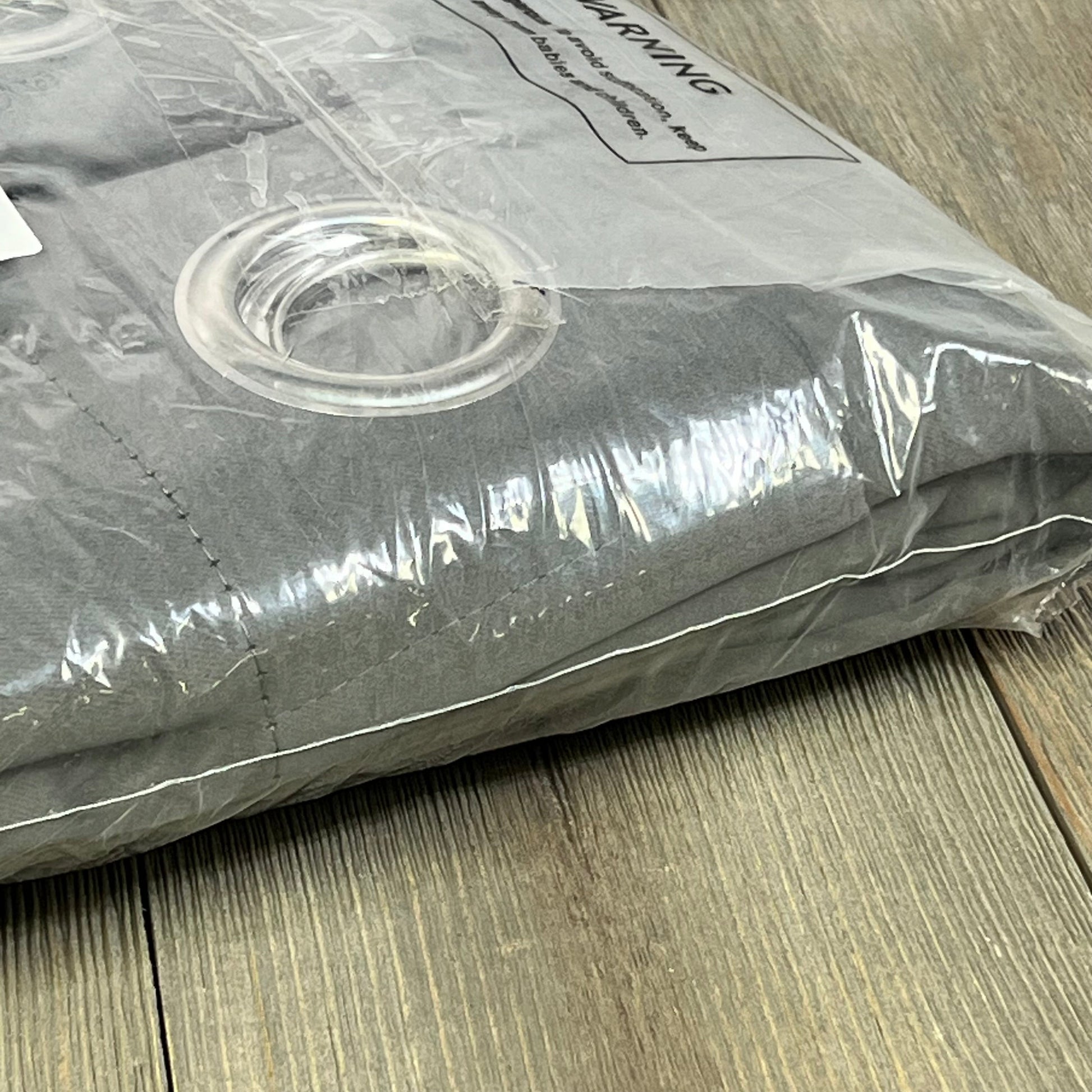 Joydeco extra long dark grey blackout curtains in packaging, featuring grommet tops for easy installation, 108 inches long.