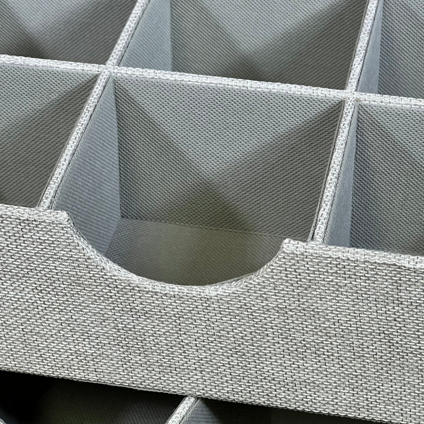 Gray woven drawer organizer tray with multiple compartments for household essentials, perfect for tidying up spaces.