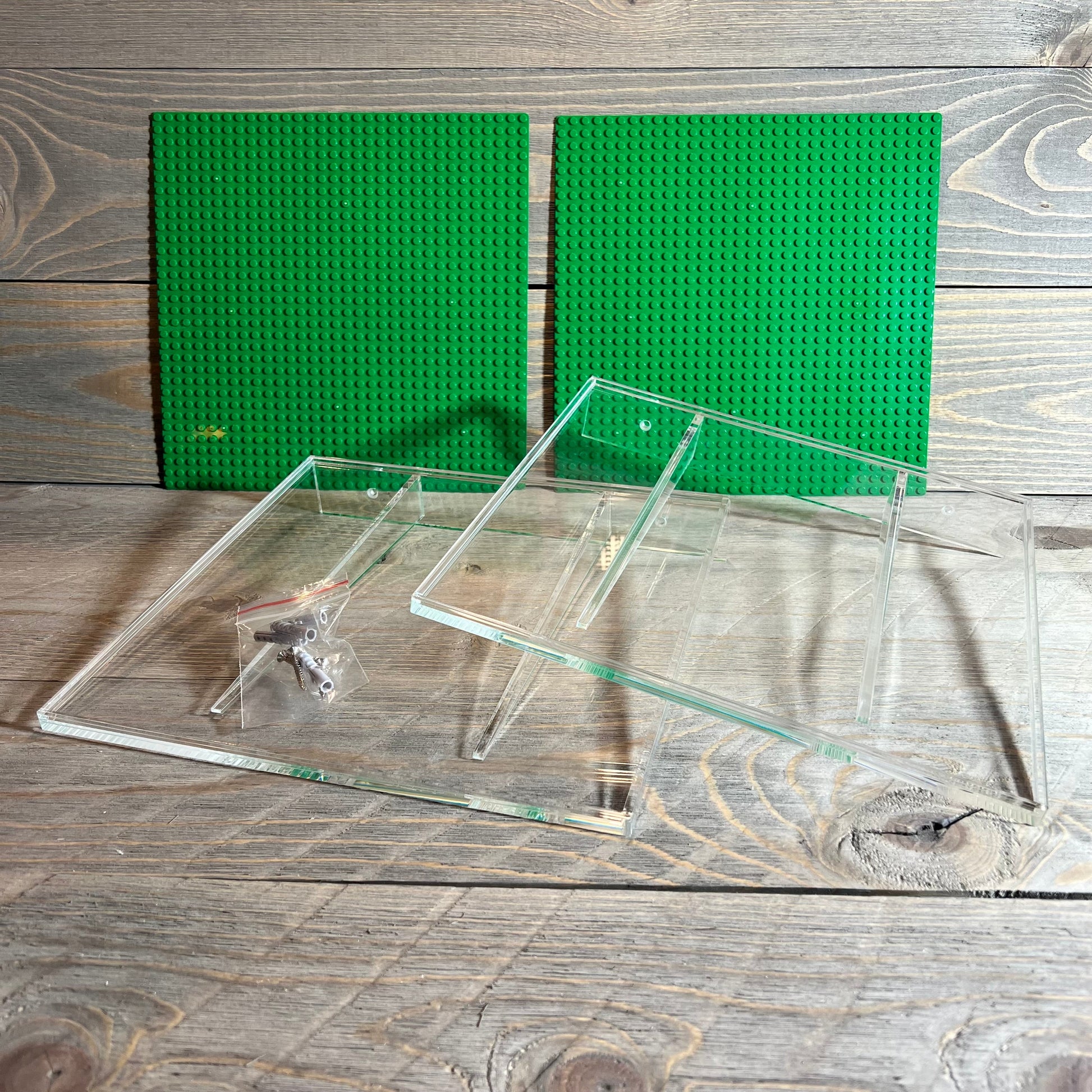 Green acrylic wall mount shelves and baseplates for displaying minifigures, compatible with Lego and other brands.
