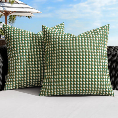 Green farmhouse-style outdoor pillow covers on a patio sofa, perfect for garden and balcony decor, 18x18 inch, waterproof.