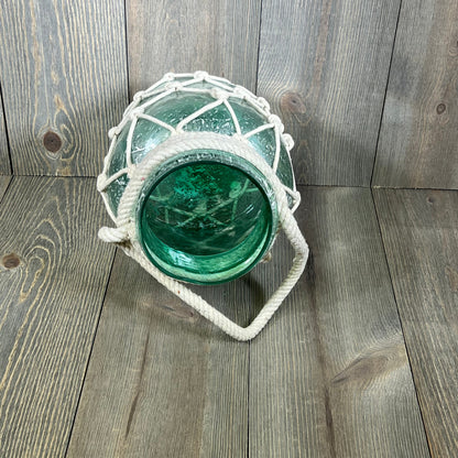 Coastal glass lantern with rope netting, perfect for beach-themed decor, 7" x 7" x 15", in vibrant blue.