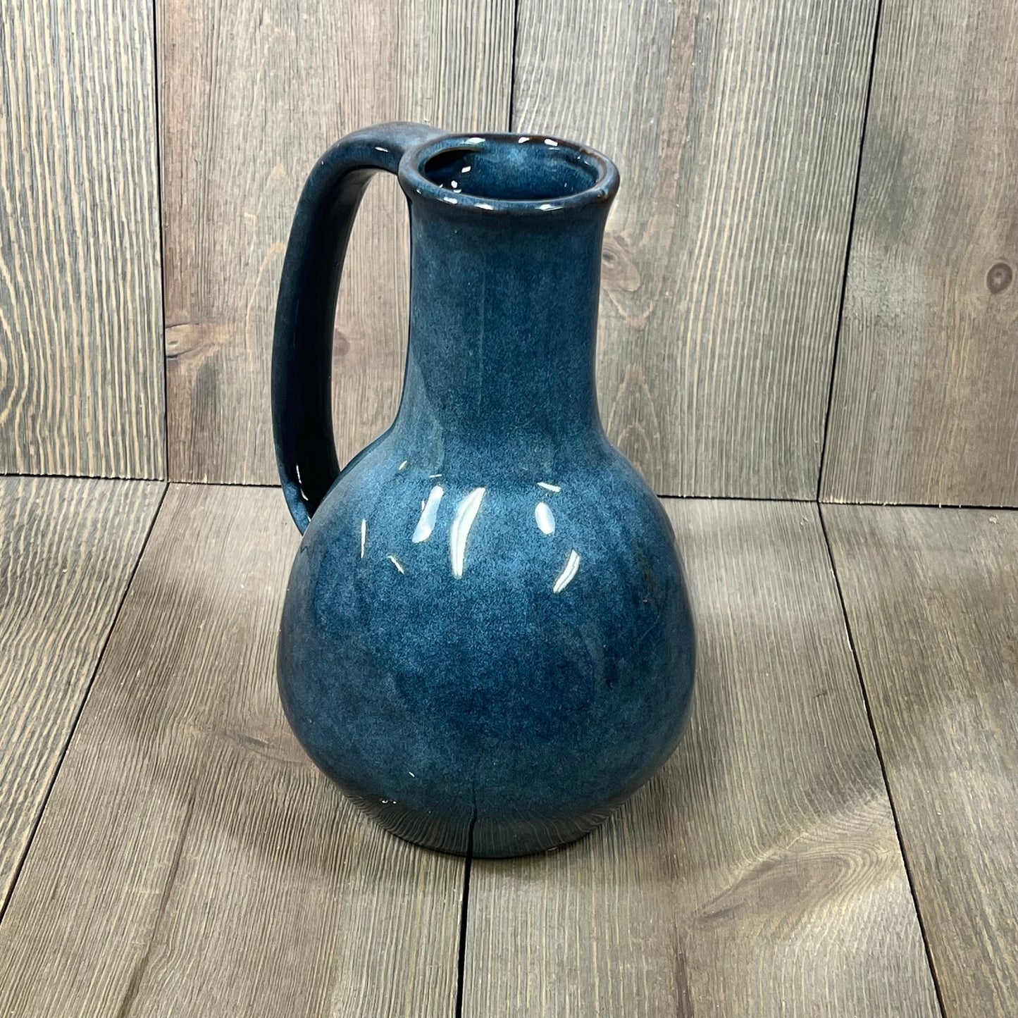 Elegant blue ceramic vase with large handle, perfect for modern farmhouse decor and dining table centerpiece.
