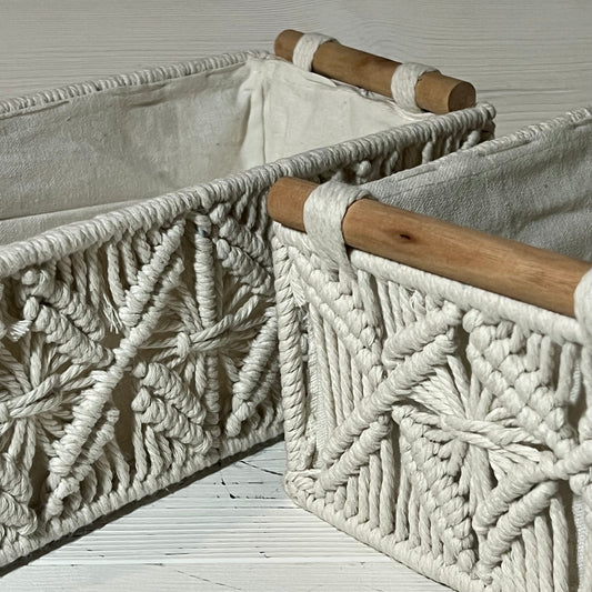 Handwoven macrame storage baskets with wooden handles in ivory white, perfect for organizing bathroom or bedroom spaces.