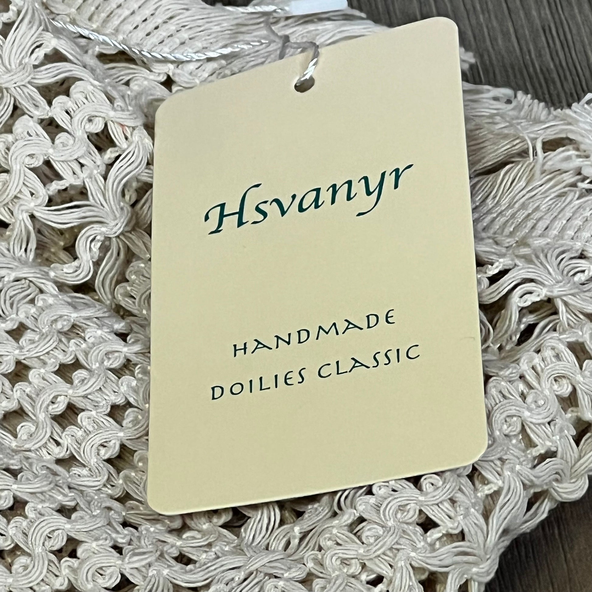 Cream beige macrame table mat with tassel, featuring Hsvanyr tag, handmade cotton linen for farmhouse dining decor.