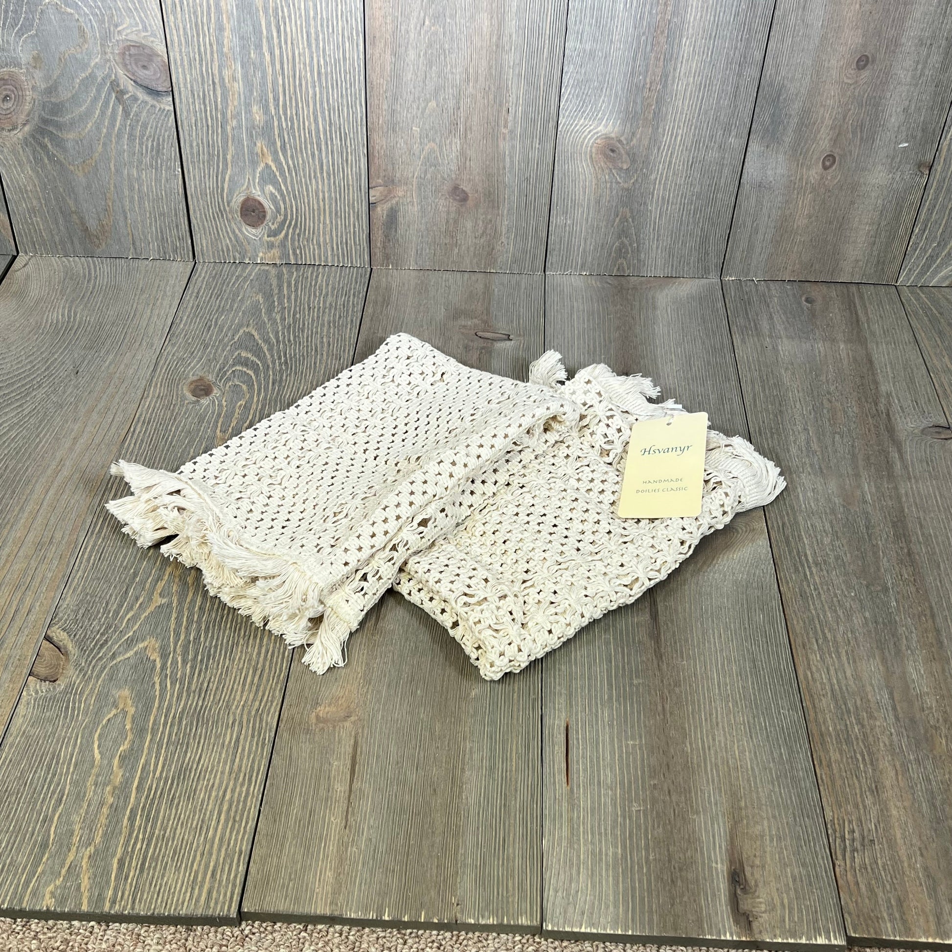 Cream beige macrame table mats with tassels on wooden surface, perfect for farmhouse dining decor.