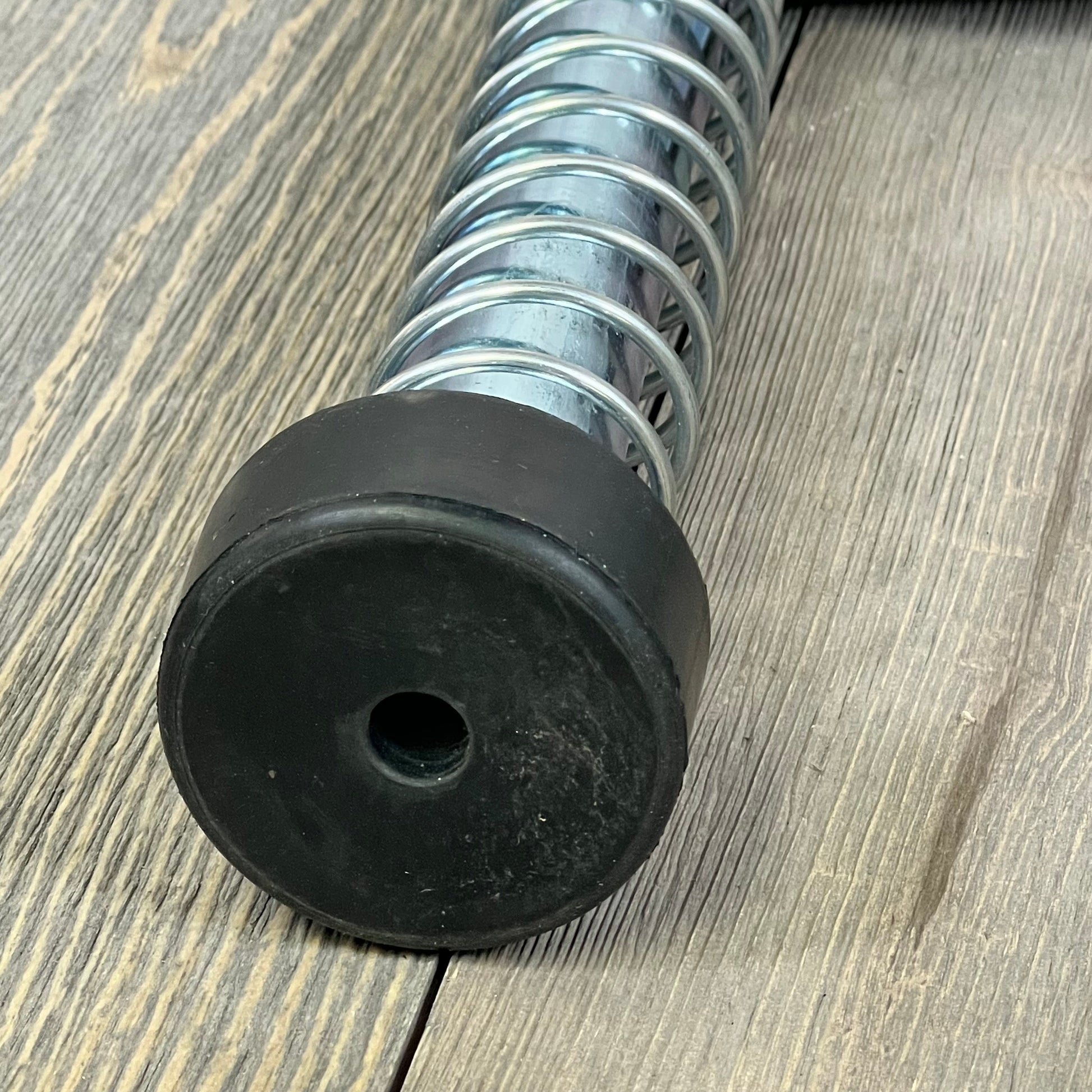 15" garage door plunger spring with rubber bumper on wooden surface, part of LAJIAOZ opener system.