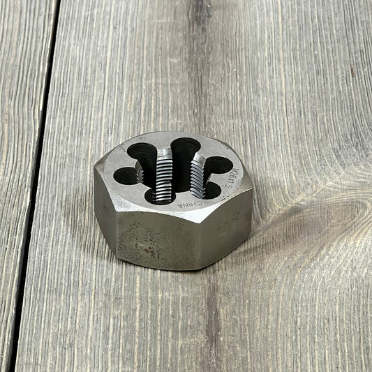 Carbon steel hex rethreading die, M26 X 1.5, on wooden surface, ideal for precise thread repair in machinery.