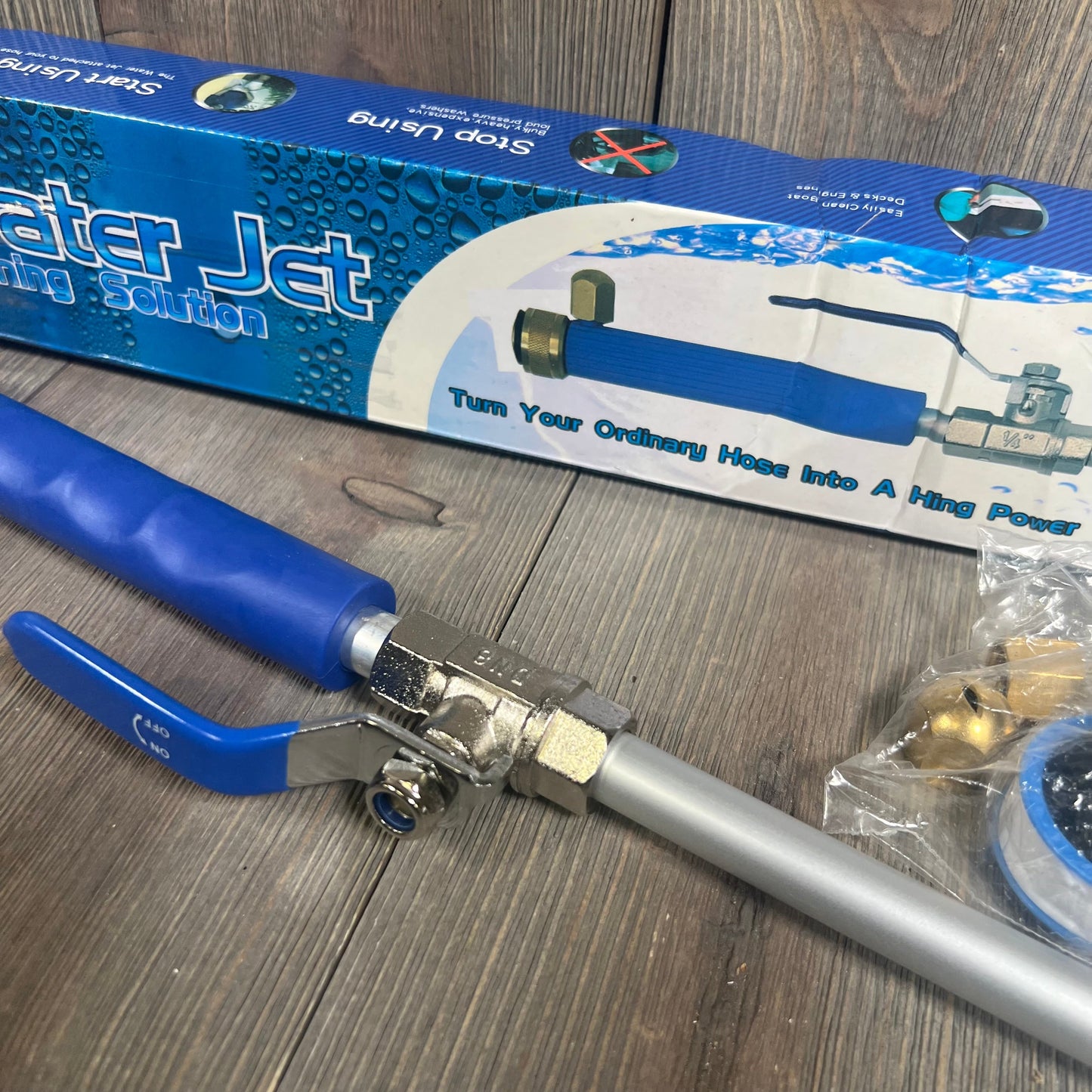 Blue Rerennco hose nozzle with quick connectors, showcasing packaging with water jet cleaning features on wooden background.