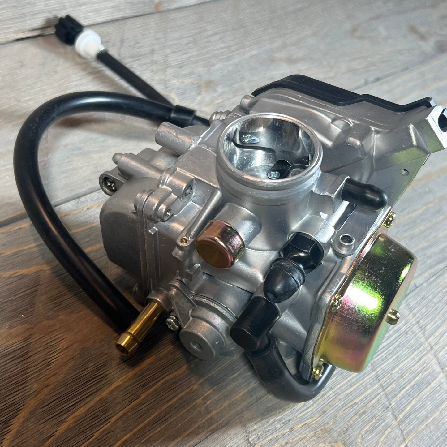 High-quality MOTOKU carburetor for Suzuki Eiger 400 LTF400, compatible with 2002-2007 models, shown on a wooden surface.