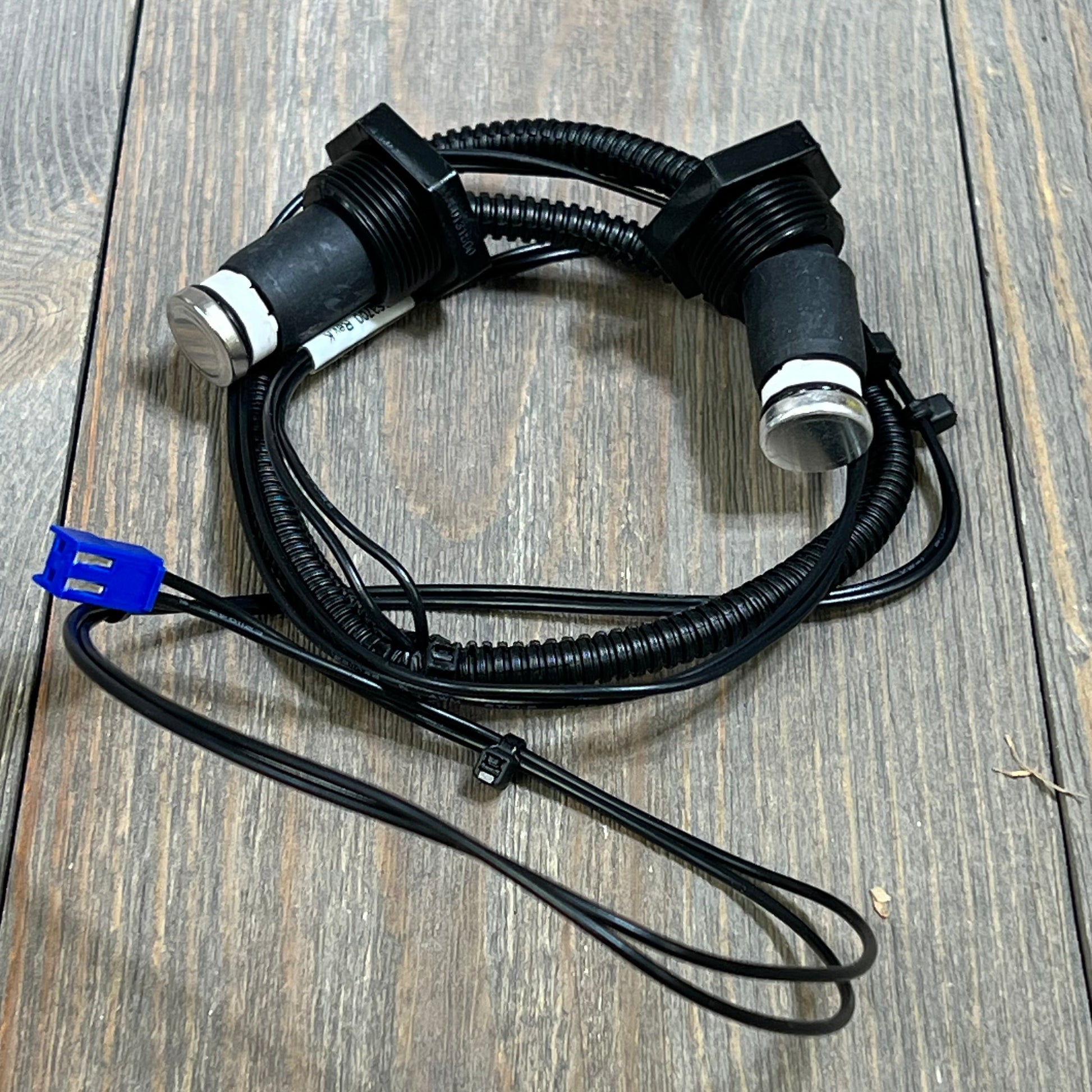 High Limit Switch Wire Harness Assembly for Zodiac Jandy heaters, shown coiled on a wooden surface.