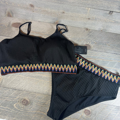 High waisted ribbed bikini set with colorful zigzag trim on a wooden background, size XXL.