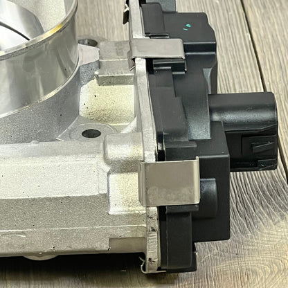 Close-up of TUCAREST electronic throttle body assembly for 05-07 Buick Rainier, 07-08 Escalade, and Chevy trucks.