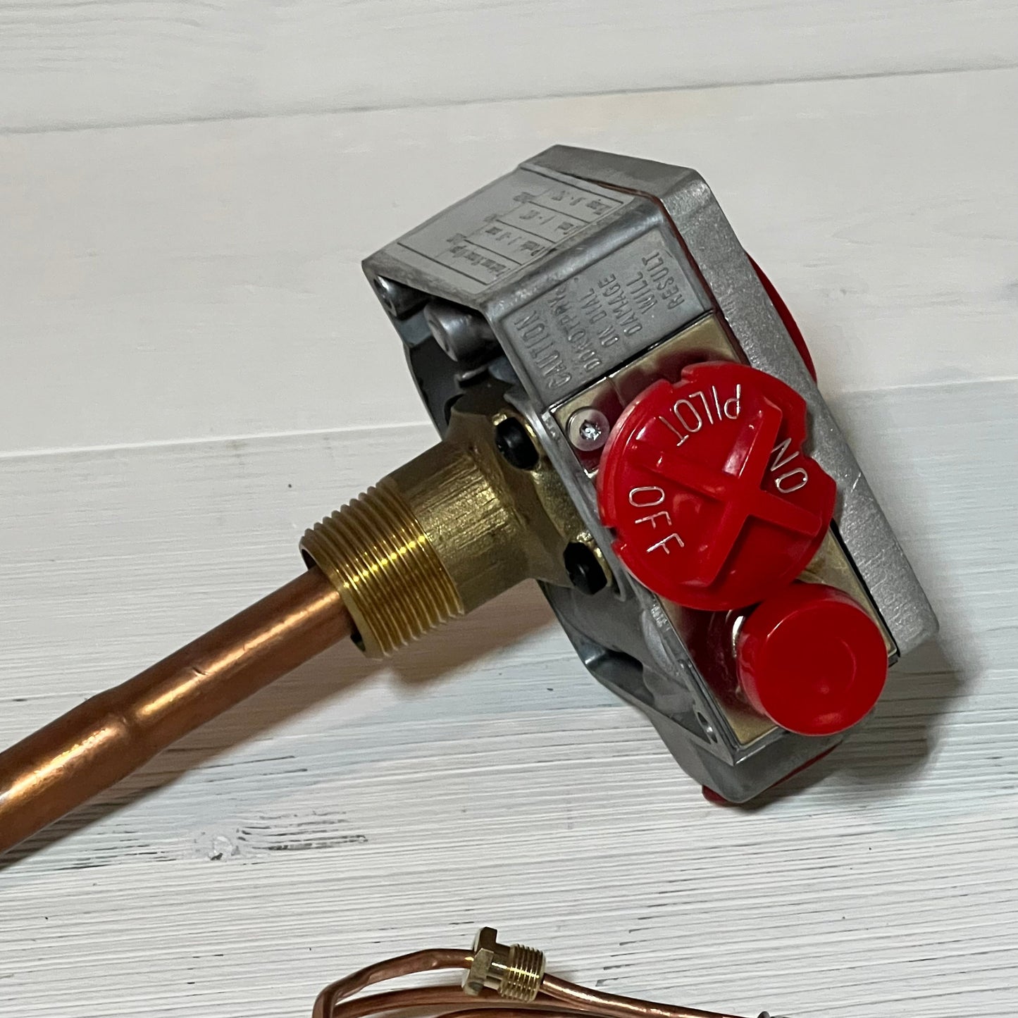 Natural gas water heater valve with red control knob and 1-3/8" shank, ideal for efficient thermostat regulation.